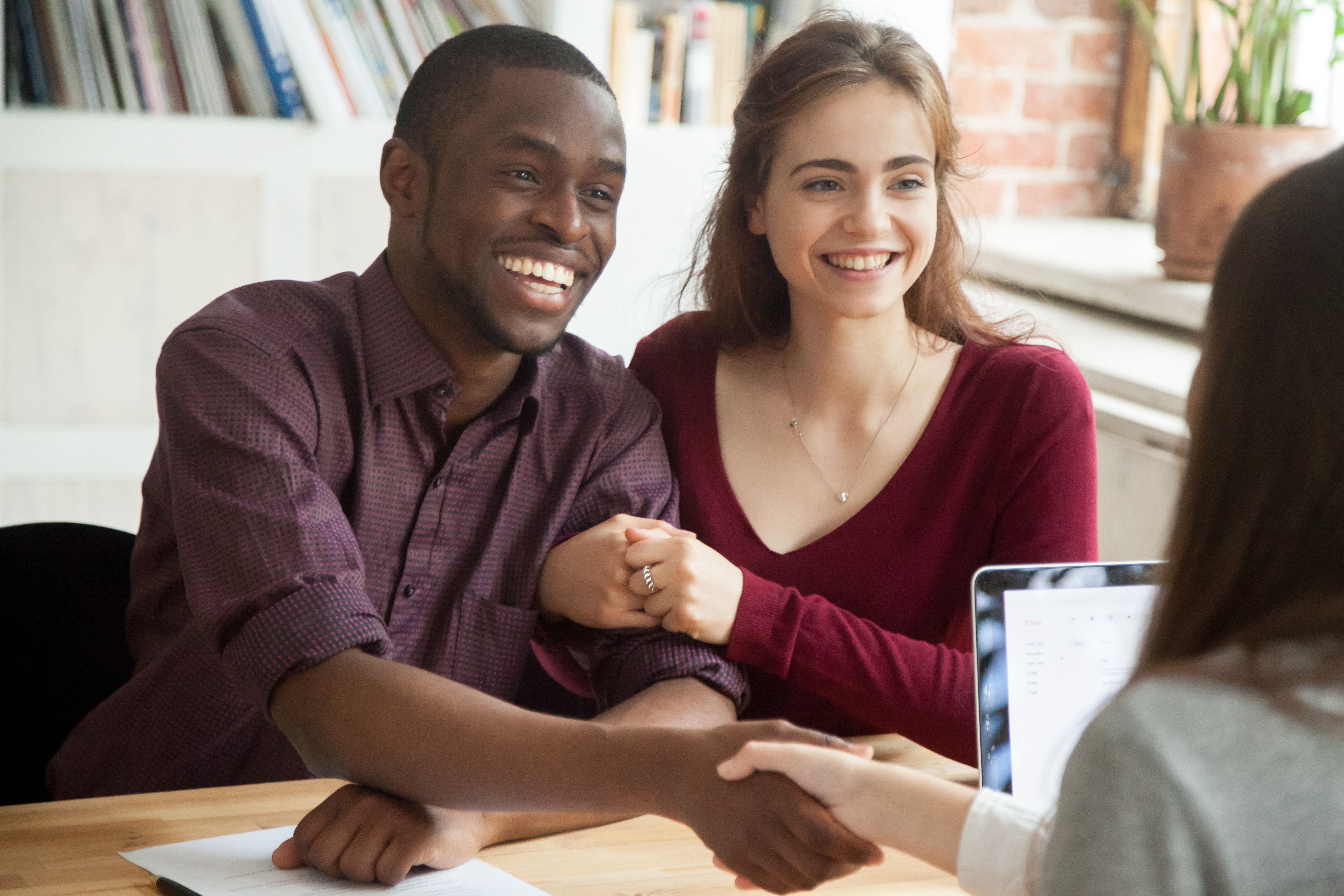 couple shaking hands with professional